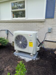 Brothers Comfort Services setting up a ductless air conditioning unit for an older home